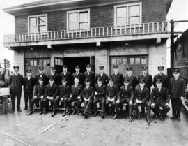 [Group portrait of South Vancouver Fire Department firefighters assembled in front of headquarter...