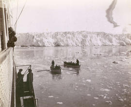 [Rowboats from the S.S. "Queen" near a glacier]