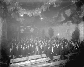 [Men gathered in Buntzen Lake Power Plant's number two high tension switch room for concert celeb...