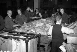 [Employees sorting Christmas parcels at the post office]