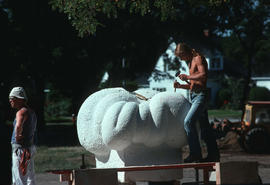 Assistant working on Michael Prentice's sculpture, Prentice on left