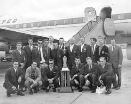 Group portrait of Firefighters soccer team, Kennedy Cup winners, on airport tarmac