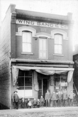[Yip Sang with children and unidentified men in front of Wing Sang Company building at 51 East Pe...