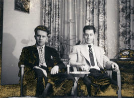 [Joseph Selsey and unidentified man seated in living room]