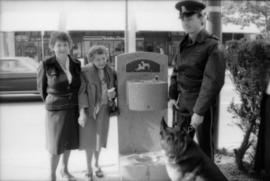 Unidentified woman, Theresa Galloway, Constable Rob Bosley and police dog Sport at drinking fount...