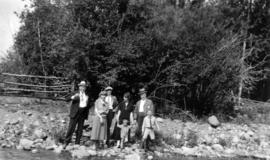 Board of Trade [trip - Board members standing next to river with women and children ]