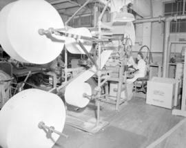 [Woman operating paper roll machine for] Pacific Mills