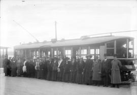 [Men and women assembled outside stepless streetcar before trial run]