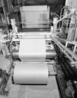 [Man operating paper machine for] Pacific Mills
