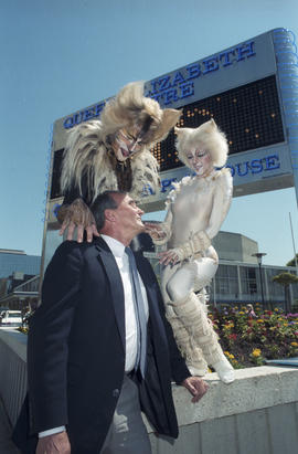 George Puil with Cats cast members in front of the Queen Elizabeth Theatre Bank of Montreal signb...