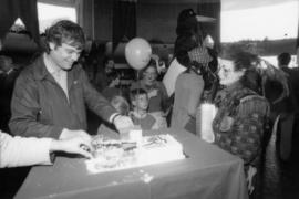 Man cutting birthday cake