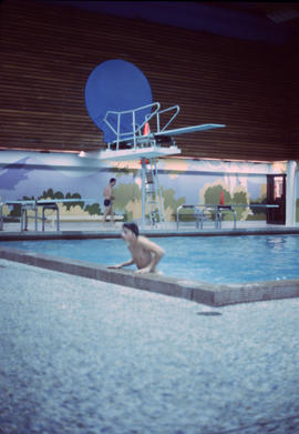 [Boy leaning out of pool]