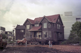 [Wide view of Hodson House raised on wheels during house relocation, 2 of 3]