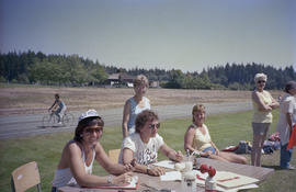 People seated at table during field hockey tournament