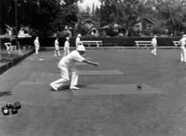 Lawn bowling game in action with 31st in background