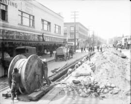 [Men laying power cables under Smithe Street]