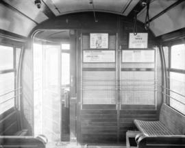 [Interior view of front bulkhead of streetcar number 294, showing posted signs and entrance to mo...