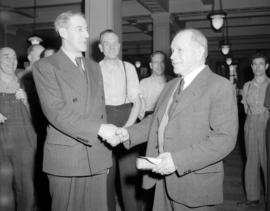 [Two men shaking hands at the opening or completion of the new B.C. Telephone Co. building]