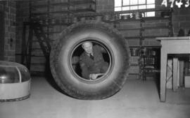 [Airman looking at airplane tire in the R.C.A.F. equipment depot #2]