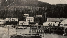 Arrandale cannery and buildings along wharf with floating dock and boats