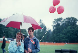 Man and woman under umbrella during the Centennial Commission's Canada Day celebrations