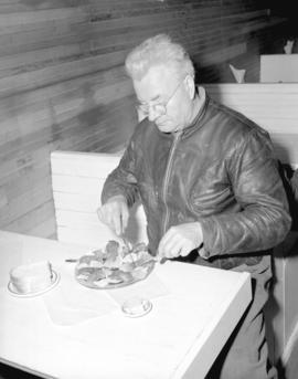 [A man eating oysters at] Oyster Bay