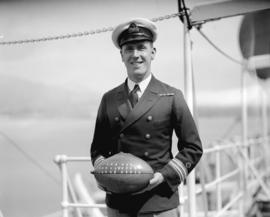 Mr. [William F.] Taylor - Purser of "Empress of Asia" [holding a souvenir rugby footbal...