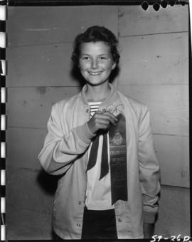 Girl holding ribbon from 1959 P.N.E. 4-H Clubs and Future Farmers of Canada Show