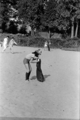 Girl Guide picking up litter from beach