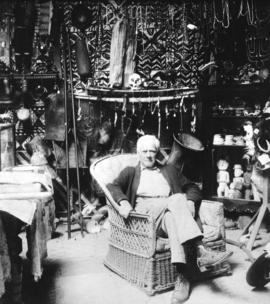 [Dr. Frank Burnett surrounded by his collection of South Seas' artifacts]