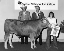 1977 P.N.E. 4-H Club competition winner, P.N.E. 4-H Chairman, and judge pose with livestock and p...