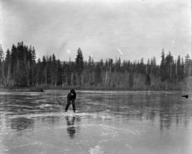 [Man on frozen lake, possibly Lost Lagoon]