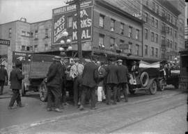 Group of men on the street with the Cobalt Hotel in the background