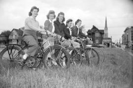 [Women on bicycles in a field, taken for Canadian Youth Hostels]