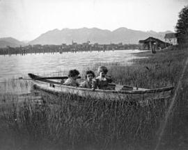 [James, Herbert and Hugh Matthews in a canoe on the south shore of False Creek]