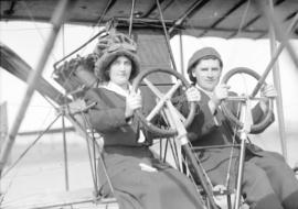 [Mr. and Mrs. William McIntosh Stark behind wheels of Curtiss School airplane]