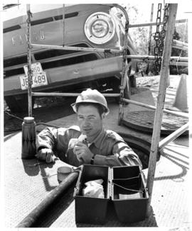 Bill Taylor in manhole taking lunch break