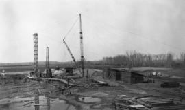 Construction site with cranes and outbuildings