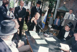 Mayor Harcourt speaking into telephone during reenactment of Vancouver's first City Council meeti...