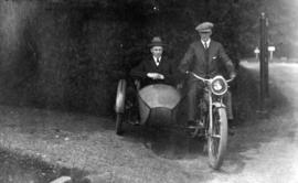 [James Crookall riding motorcycle with sidecar]
