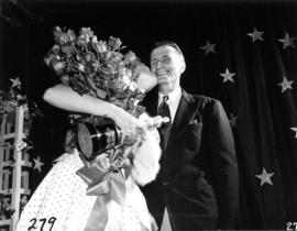 Glenda Sjoberg, winner of Miss P.N.E. 1955, kissing a man on the cheek