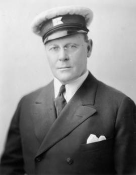 Eric W. Hamber in yachting hat and eyeglasses