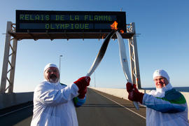 Day 25 Torchbearer 25 Albert McRobb passing the flame to the Torchbearer 26 Paul Phillips under t...