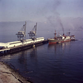 Ship at dock at BC Sugar with cranes for loading and unloading ships