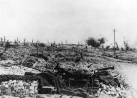 Shells bursting in a village on the Canadian front