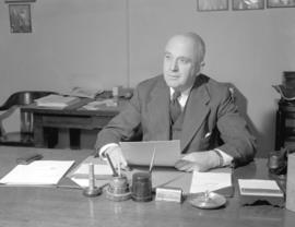 Mr. Wilkinson [seated at a desk]