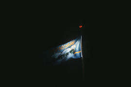 Centennial flag at night