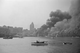 [View of Pier "D" engulfed in smoke and flames]