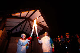 Day 27 Torchbearer 149 Corey Groves passing the flame to Torchbearer 150 Sarah Fitzpatrick in Fre...