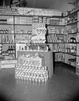 [Burns' canned meat and Bendix Home Laundry display in a grocery store]